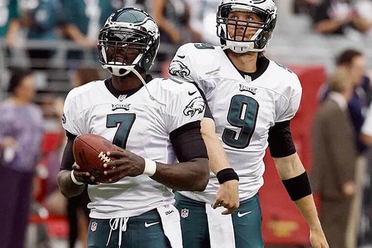 Philadelphia Eagles' Michael Vick (7) and Nick Foles (9) warm up prior to an NFL football game against the Arizona Cardinals Sunday, Sept. 23, 2012, in Glendale, Ariz. (AP Photo/Ross D. Franklin)