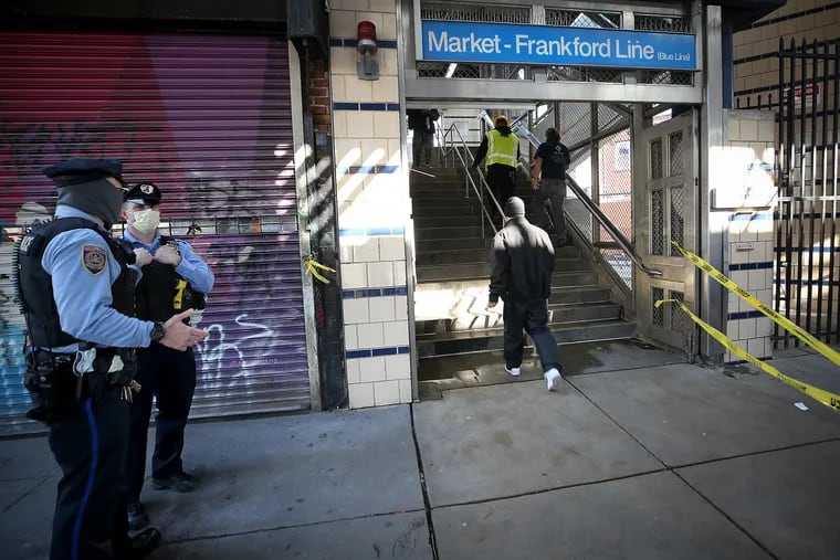 Transit police officers stand near the entrance of SEPTA’s Somerset Station as it reopens in Kensington. Some maintenance work is continuing.