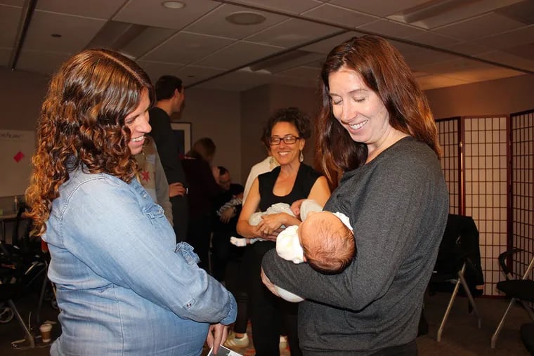 Andrea Moffat (left) admires Kate Galecki's newborn daughter at a session of CenteringPregnancy at Northwestern Medicine in Chicago. Over the past five years, the number of practices that offer the program has nearly doubled.