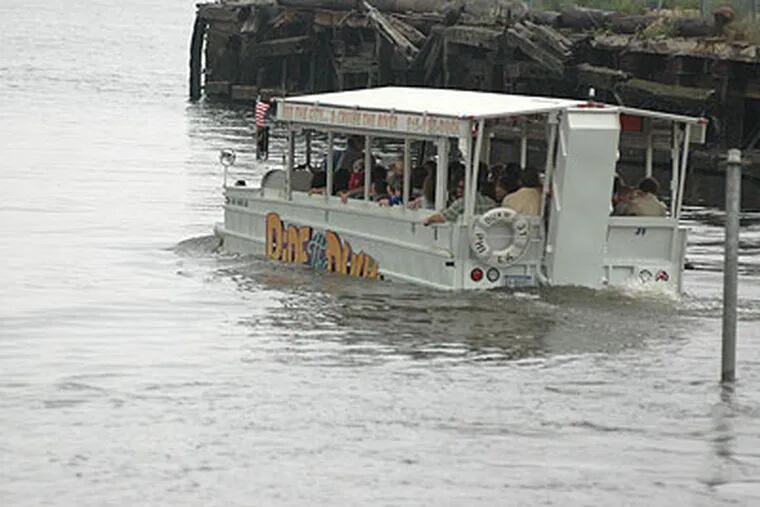 A Ride The Ducks boat drives into the river at Race Street and Delaware Avenue. (Krystle Marcellus / Staff Photographer)