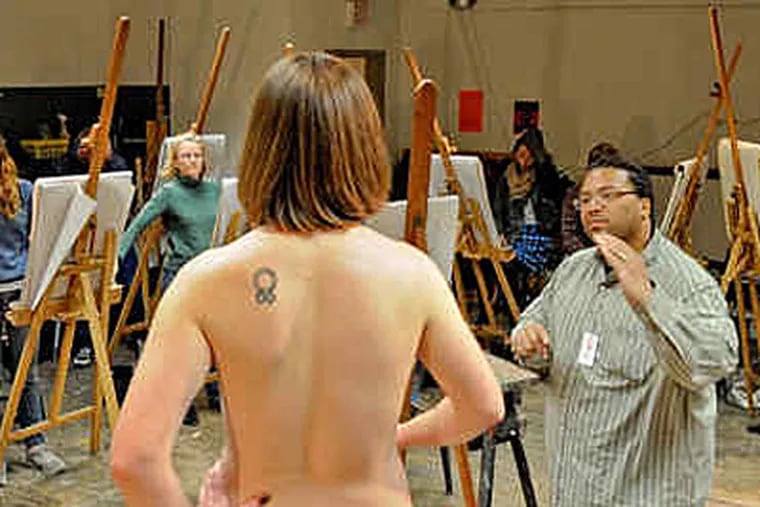 Model Heather Dierickx waits patiently as Fleisher Art Memorial art instructor Bernard Collins Jr. discusses the finer points of figure drawing with his introductory-class students. (Clem Murray / Staff)