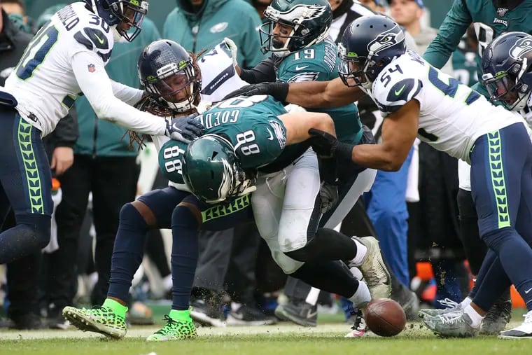 Eagles tight end Dallas Goedert fumbles the ball during the fourth quarter on Sunday.
