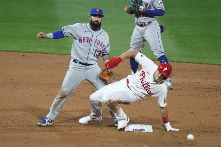 J.T. Realmuto, right, of the Phillies is out at 2nd base on a fielder’s choice hit by Didi Gregorius in the 2nd inning . Luis Guillorme of the Mets is left on April 6,, 2021.