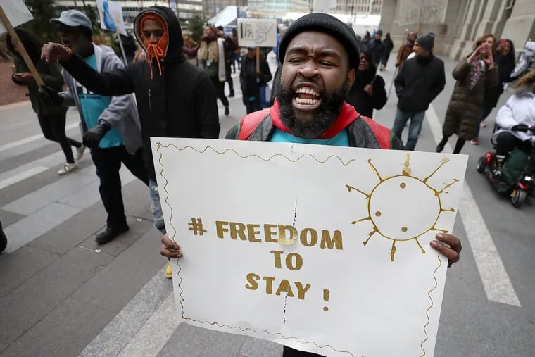 Dante McCall, of One PA, chants with fellow demonstrators as they march around City Hall in Philadelphia in February. The group was seeking protections for renters and homeowners amid a gentrifying Philadelphia.