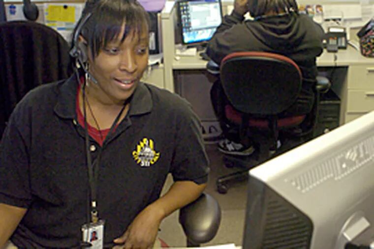 Marjorie Mosley, a representative at Baltimore City's 311 non-emergency call center, assists a citizen caller. (Colby Ware/Special to the Inquirer)