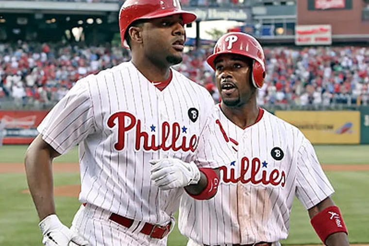 Jimmy Rollins celebrates with Ben Francisco after Francisco hit a two-run homer in the first inning. (Steven M. Falk/Staff Photographer)
