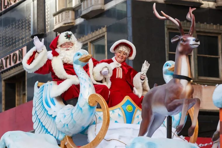 Santa Claus and Mrs. Claus greet the crowds from a float on 16th Street at the 98th Annual 6ABC Dunkin’ Donuts Thanksgiving Day Parade, Thursday, Nov. 23, 2017.