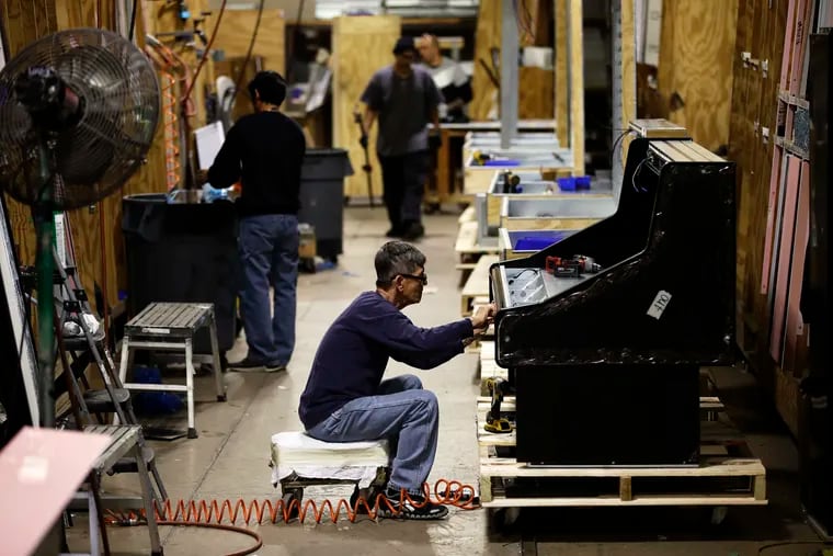 Workers build refrigerators at the Howard McCray's commercial refrigeration manufacturing facility in Philadelphia.