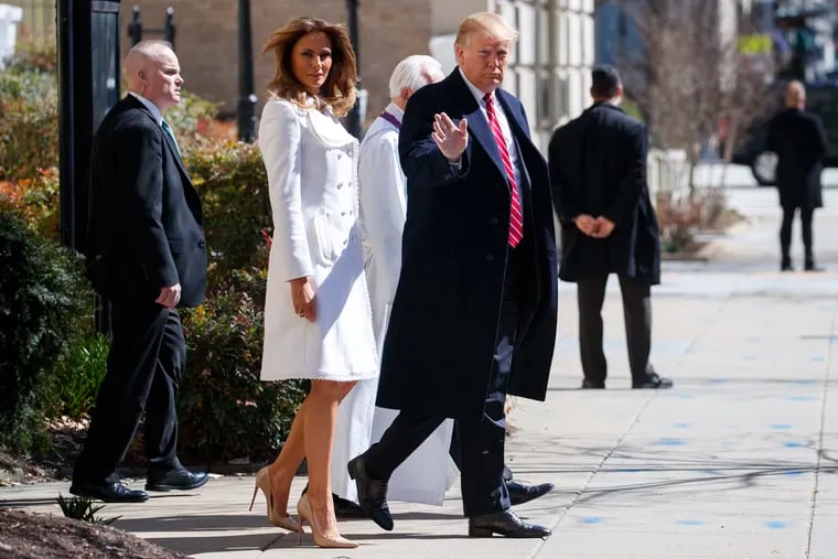 President Donald Trump and first lady Melania Trump, with Reverend Bruce McPherson, walk to their motorcade after attending service at Saint John's Church in Washington, Sunday, March 17, 2019, en route to the White House. (AP Photo/Carolyn Kaster)