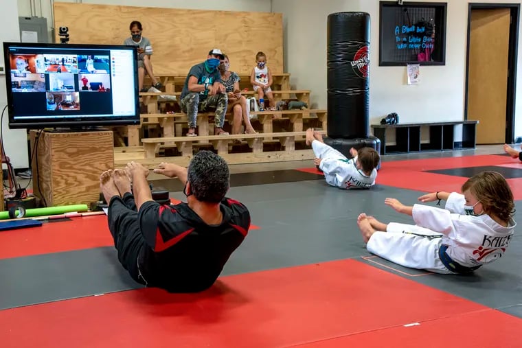 Frank LoPinto (left) teaches an in-person martial arts class while in front of the camera for a simultaneous in-person class at his Kaizen Martial Arts of N.J. in Mount Laurel.