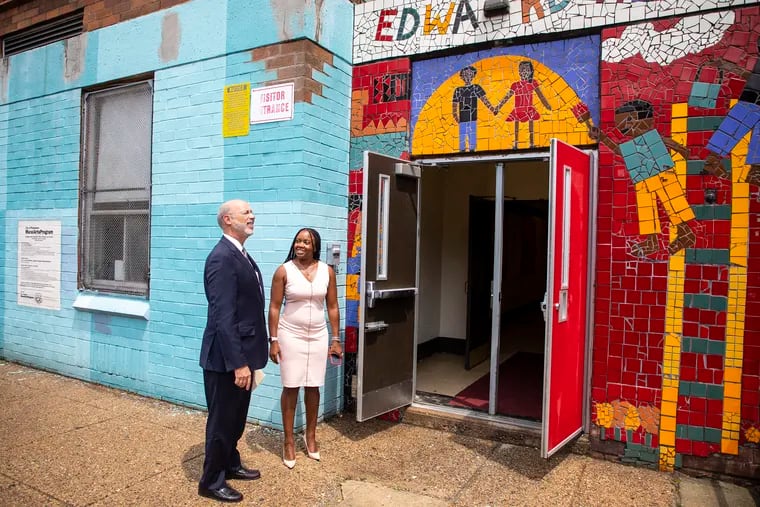 Gov. Tom Wolf arrives at Edward Heston Elementary in Overbrook, where he announced that the state would spend another $4 million for lead paint abatement in Philadelphia schools. He was greeted by Assistant Principal Audrey Fields.
