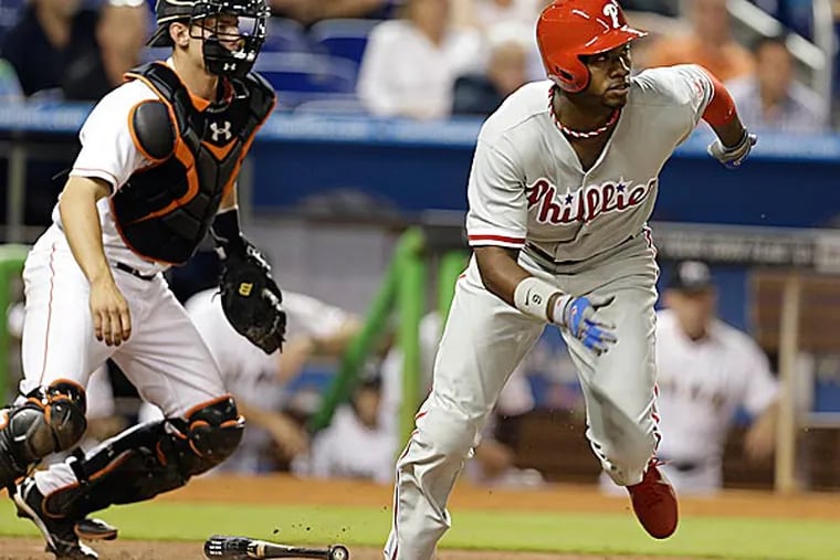 The Phillies' Domonic Brown grounds out to first to score Ryan Howard in the sixth inning. (Lynne Sladky/AP)