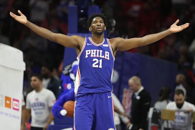 Joel Embiid of the Sixers raises his arms to the crowd at the end of the 3rd quarter. The Sixers defeated the Trailblazers 101-81 at the Wells Fargo Center on Nov. 22, 2017.