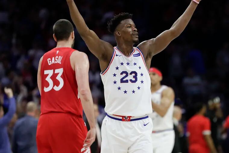 Sixers guard Jimmy Butler raises his arms after making a basket late in the first-half past Toronto Raptors center Marc Gasol during the Eastern Conference playoff semifinals on Thursday, May 9, 2019 in Philadelphia.