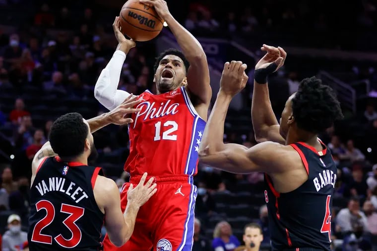 Sixers forward Tobias Harris drives to the basket against Toronto Raptors guard Fred VanVleet and forward Scottie Barnes in the first quarter on Thursday.
