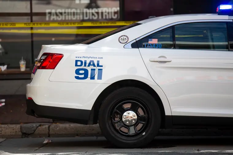 Philadelphia Police Department car with the decal "Dial 911," on the passenger side on the back of the vehicle.