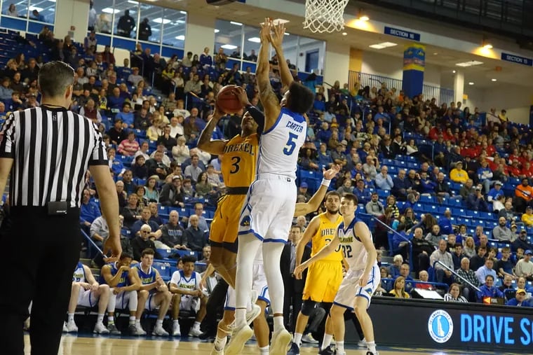 Drexel's Troy Harper scores over Delaware's Eric Carter in the first half.