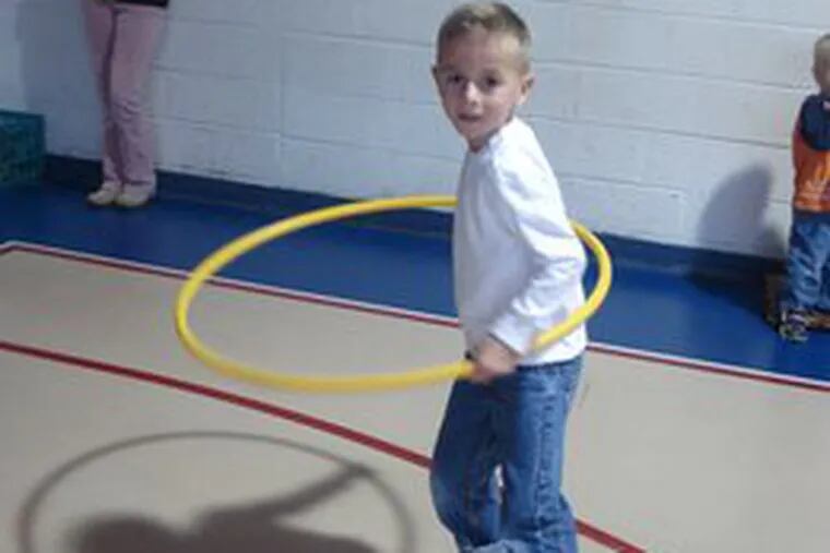 Jack Steel, a Nokomis School student, tries his hand with a hula hoop during a celebration of the 1950s at the Medford Lakes school.