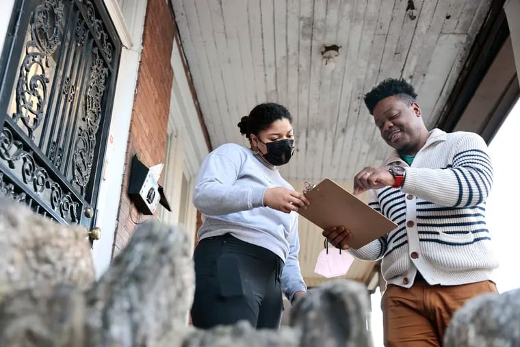 Summer Nelson (left) signs Steve Paul’s (right) petition. Paul is running for committeeperson in his West Phila. neighborhood and was collecting petition signatures so he can get on the ballot for the primary. Steve was photographed on March 11, 2022.