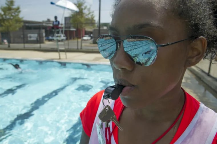 At the Athletic Rec Center pool (1400 N. 26th St.), first-year lifeguard Khadijah Davis, 17, a senior at CAPA, watches a swimmer in the pool.