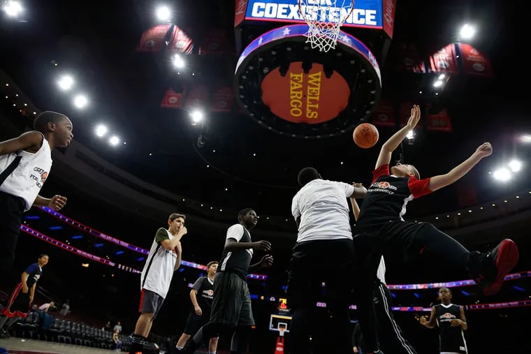 A group of Jewish and Muslim middle-schoolers play basketball game together at The Wells Fargo Center in Philadelphia on November 30, 2016.