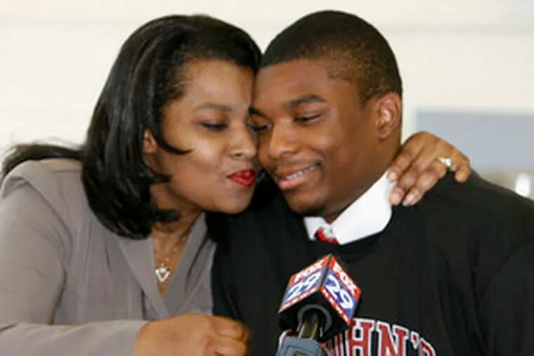 Northeast High&#0039;s Sean Evans is congratulated by his mother, Leshia Evans, after announcing he had accepted a St. John&#0039;s scholarship.