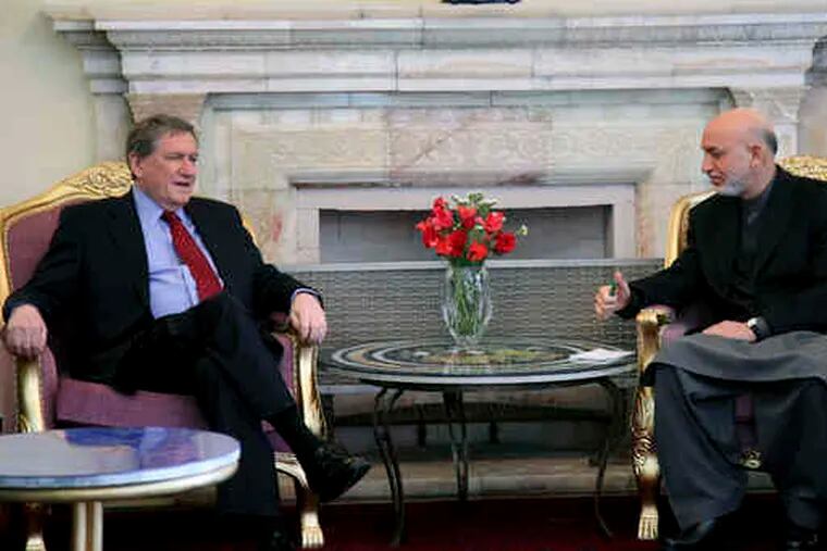 During a visit to Kabul, U.S. envoy Richard Holbrooke (left) conferred yesterday with Afghan President Hamid Karzai at the presidential palace. Holbrooke arrives in Pakistan today.
