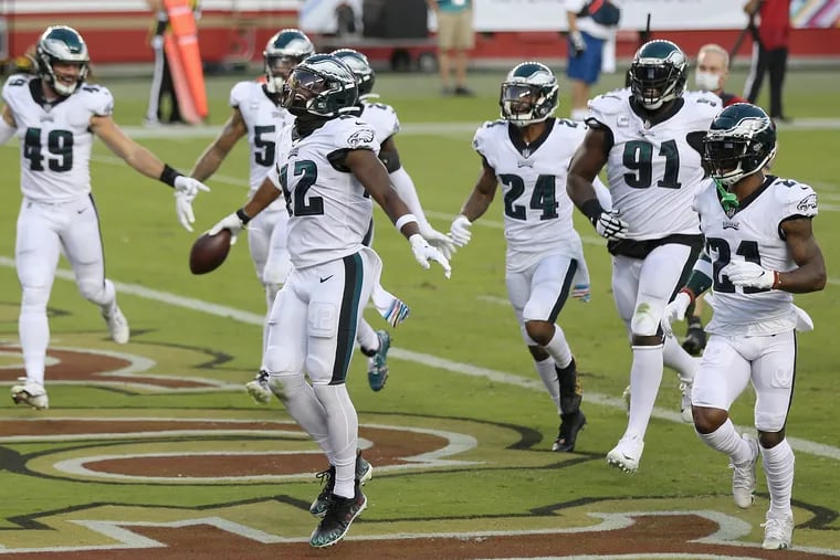 Eagles safety K'Von Wallace (center) celebrates an interception by teammate Rodney McLeod against the 49ers on Oct. 4.