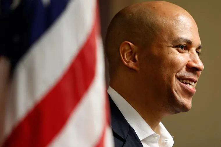 Newark Mayor and U.S. Senate candidate, Cory Booker, smiles during a stop at the North Gate Senior Complex on August 12, 2013. ( DAVID MAIALETTI / Staff Photographer )