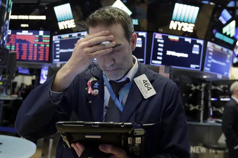 FILE photo shows trader Gregory Rowe on the floor of the New York Stock Exchange.