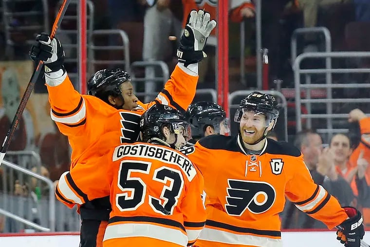 Flyers' Wayne Simmonds celebrates his second-period goal with teammate Shayne Gostishehere and Claude Giroux against the Pittsburgh Penguins on Saturday, April 9, 2016 in Philadelphia.  YONG KIM / Staff Photographer
