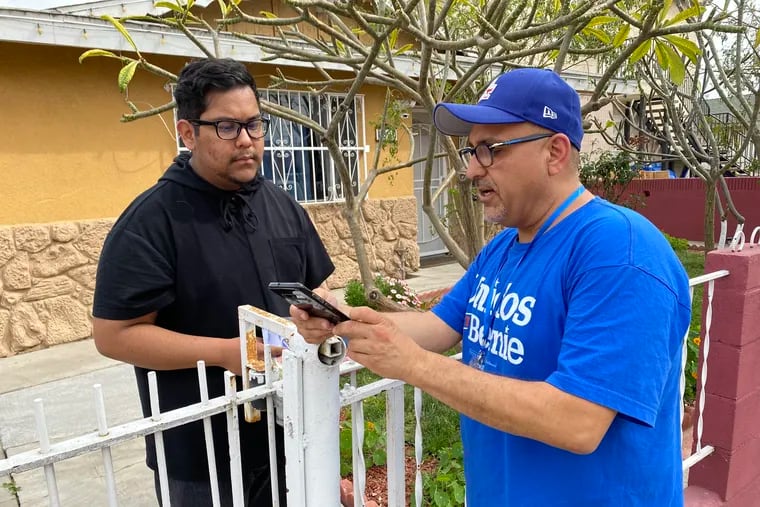 In East LosAngeles, Bernie Sanders campaign volunteer Saúl Sarabia makes his pitch to a 19-year-old first-time voter, Angel Espinoza.
