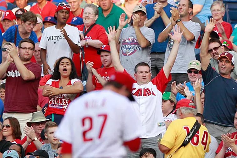 Fans cheer as Aaron Nola walks off the mound. (Charles Fox/Staff Photographer)
