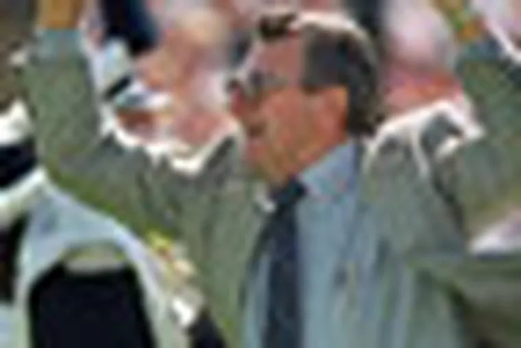 FILE - In this Sept. 12, 1998 file photo, Penn State football coach Joe Paterno cheers on his players as he runs onto the field before a game against Bowling Green in State College, Pa. Paterno say he plans to retire at the end of the season, his long and illustrious career brought down because he failed to do all he could about an allegation of child sex abuse against a former assistant. (AP Photo/Chris Gardner, File)