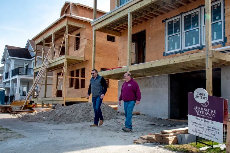 Realtor Brian Hiltner (left) meets with electrician Greg McDonal at a home under construction in 2020 in Margate at the Jersey Shore. Home buyers in the Philadelphia metro area paid almost 50% more per square foot for a new home in 2023 than they did in 2018, according to a report by Clever Real Estate.