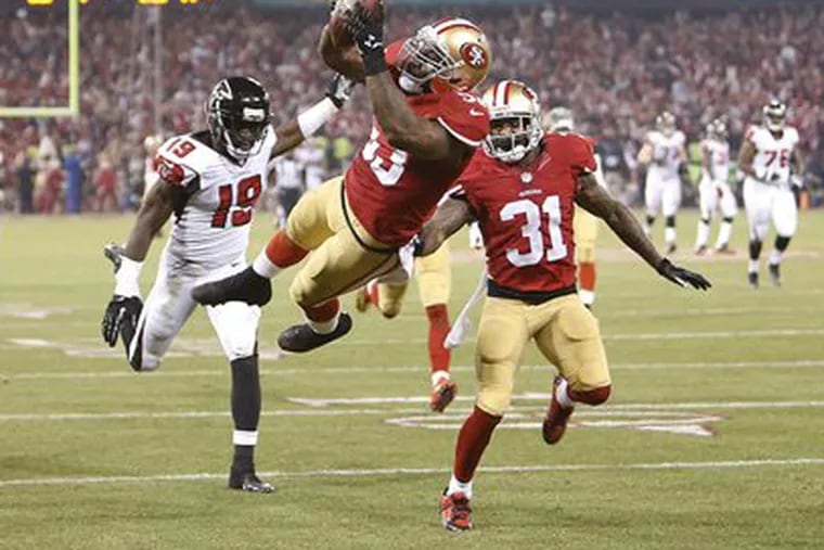 San Francisco 49ers linebacker NaVorro Bowman dives into the end zone after returning an interception 89 yards for a touchdown during the fourth quarter.