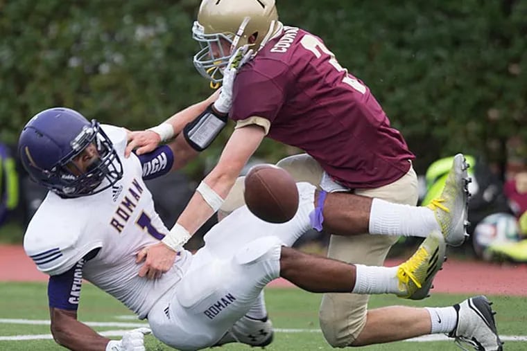 Roman Catholic's AJ Frazier is hit by Haverford's Tommy McNamara. (Ed Hille/Staff Photographer)