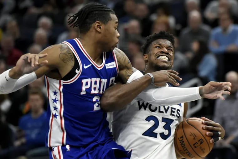 Timberwolves guard Jimmy Butler  drives against Richaun Holmes of the Sixers  during the fourth quarter.