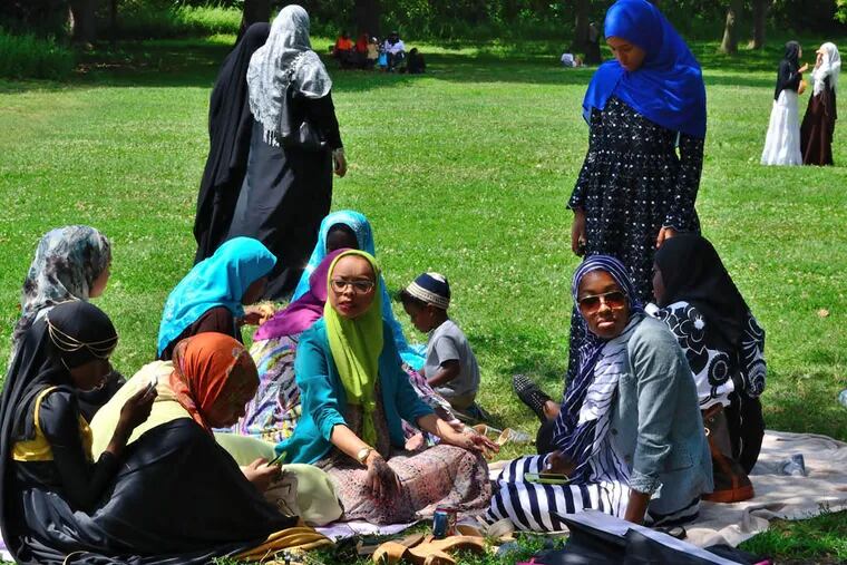 Women gather under a tree for shade at FDR Park during a celebration for the ending of Ramadan on Monday, July 28, 2014.  C.F. Sanchez / Staff Photographer
