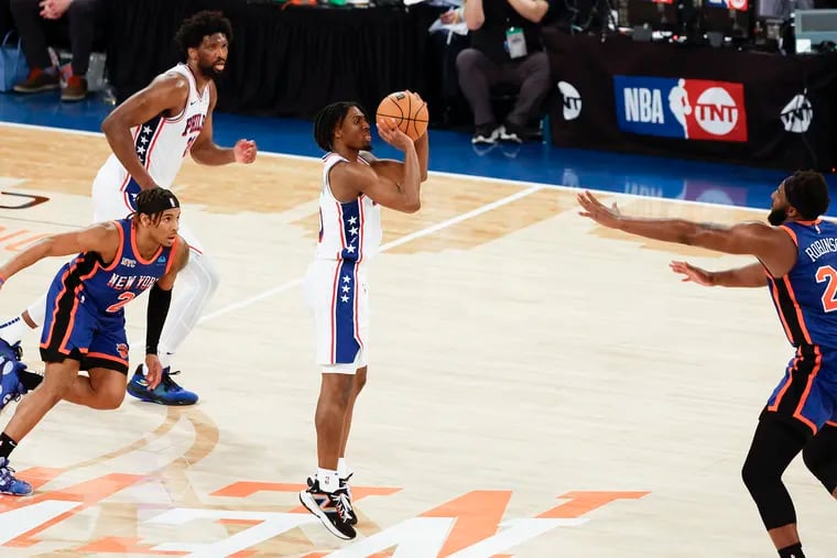 Sixers guard Tyrese Maxey shoots the game-tying three-point basket over New York Knicks center Mitchell Robinson (right) late in the fourth quarter of Game 5.