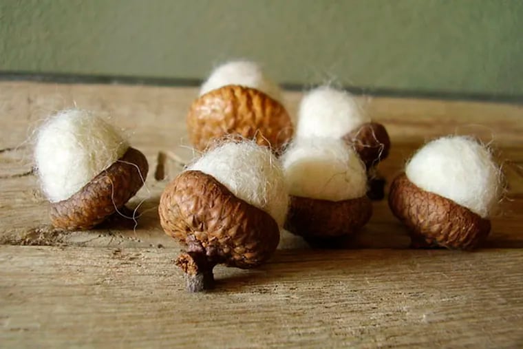 This product image provided by House of Moss shows acorns made with wool in Dundee, Ore. Alison Comfort is inspired by the forest floor to create realistic natural forms like mushrooms, pebbles, moss and acorns. Using eco-friendly wool helps her tie the organic elements of the craft together. (AP Photo/House of Moss, Alison Comfort)