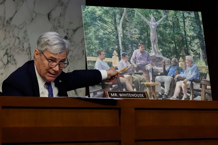 Senate Judiciary Committee member Sen. Sheldon Whitehouse (D., R.I.) displays a copy of a painting featuring U.S. Supreme Court Justice Clarence Thomas alongside other conservative leaders during a hearing on court ethics reform in the Hart Senate Office Building on Capitol Hill on May 2 in Washington, D.C.