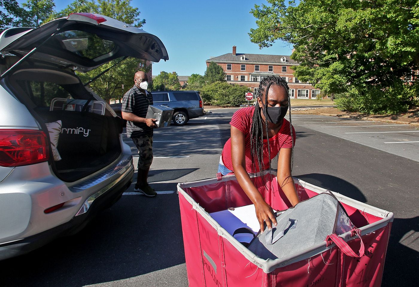 Penn State University freshman Madison Truesdale and her father Wallace Truesdale move her belongings to her resident hall on the University Park campus on Aug. 18, 2020. Freshmen were assigned a specific day and time for their move-in due to coronavirus restrictions. 