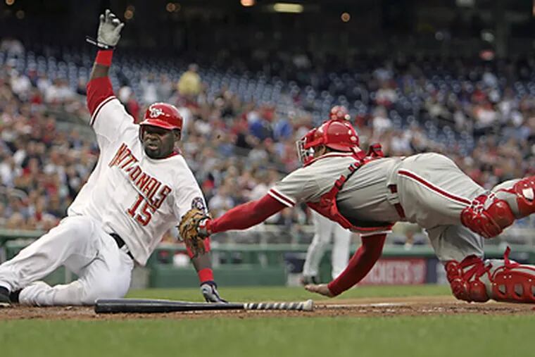 Washington's Cristian Guzman just beat Phillies catcher Carlos Ruiz's tag to score in the first inning. (Lawrence Jackson/AP)