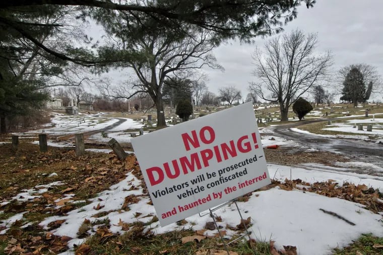 A sign at Mount Moriah Cemetery warns illegal dumpers that they will be prosecuted and “haunted by the interred.”