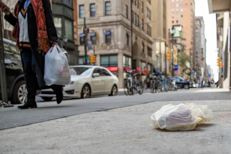 A plastic bag lays on the ground in Center City Philadelphia. A ban on single-use plastic bags will go in effect in the city on July 1.
