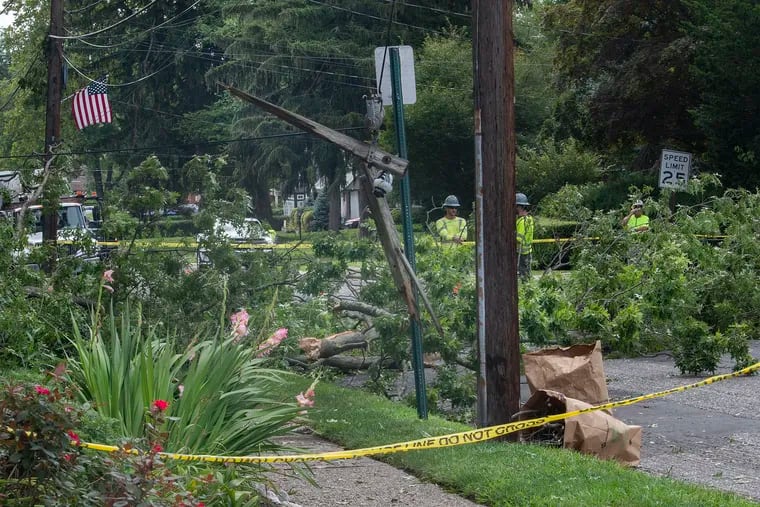 Cleaning crews work on downed electrical lines and fallen trees last week after a powerful storm hit Glenside, Montgomery County. More storms are expected Thursday.