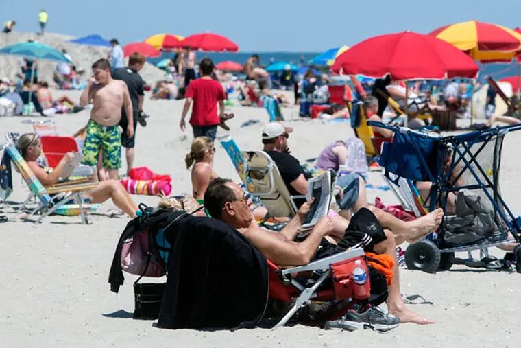 Memorial Day weekend is the unofficial start of summer. Shore-goers walked the Ocean City boardwalk and crowded the beach on a somewhat cool holiday weekend. Few people braved the cold water. (ED HILLE/Staff Photographer)