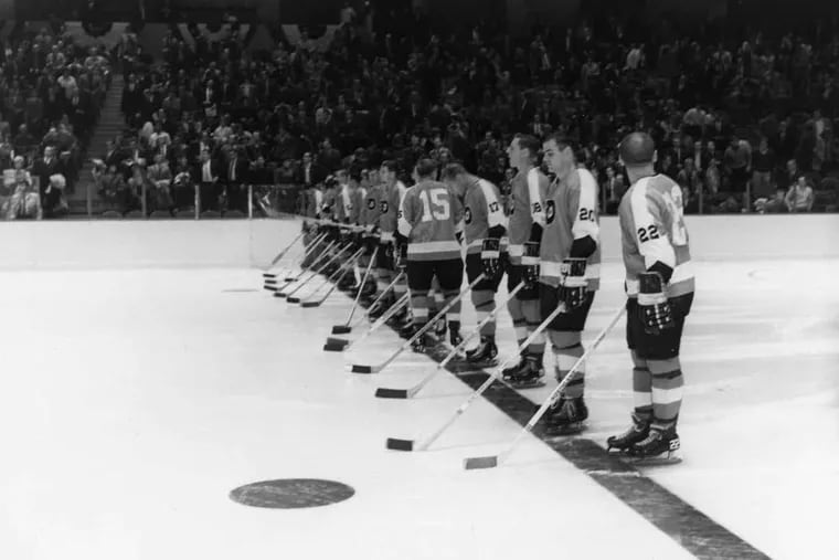 The Philadelphia Flyers line up on the blue line prior to their first game at the Spectrum on Oct. 19, 1967. None of the players in this photo wore helmets on Oct. 19, 1967 and Penguins goalie Les Binkley did not wear a mask.