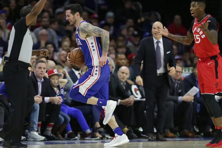 Sixers’ J.J Redick limps away after he was fouled by the Toronto RaptorsDelon Wright, right, in the Philadelphia 76ers win 117-111 over the Toronto Raptors in Philadelphia, PA on January 15, 2018. DAVID MAIALETTI / Staff Photographer